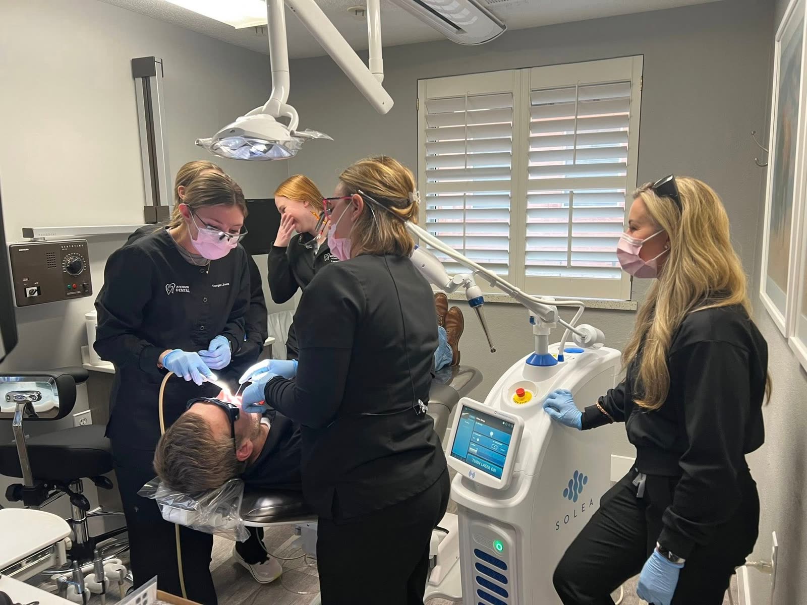 The Atchison Dental Associates team performing a Solea Sleep laser treatment in the operatory.